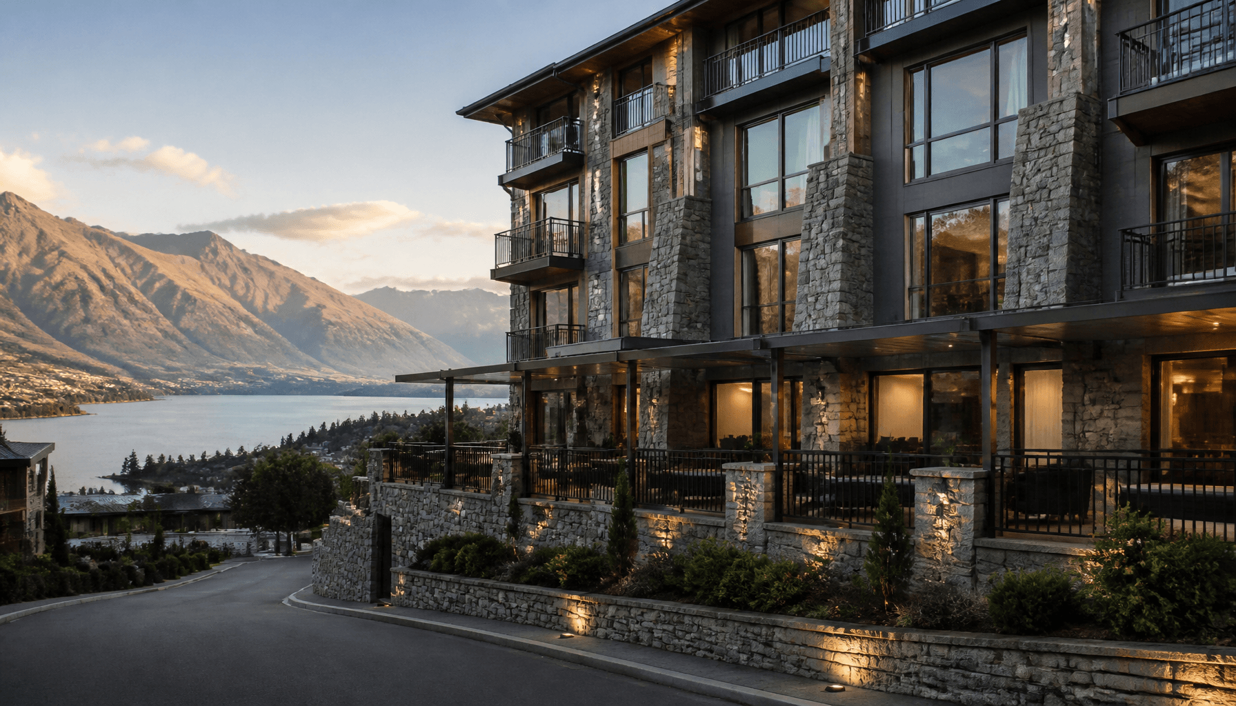 Boutique hotel exterior on a Queenstown hillside street with alpine backdrop