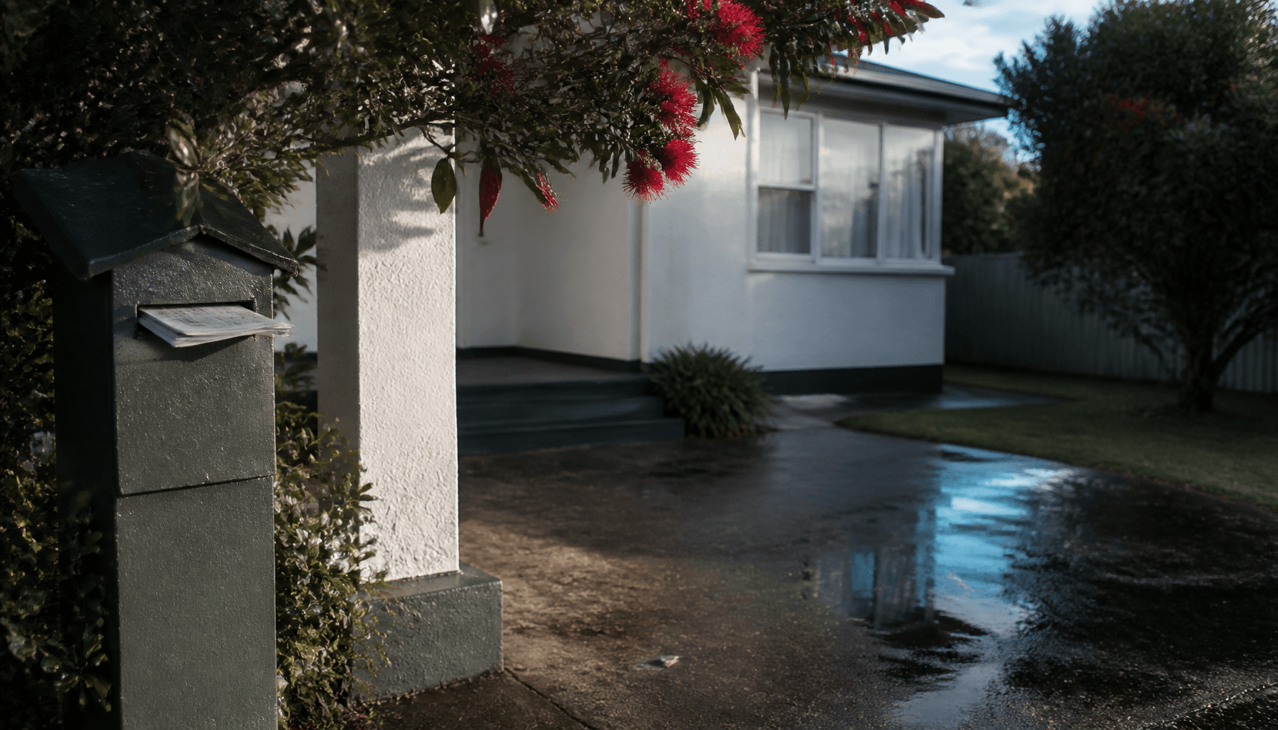 NZ suburban letterbox with a financial statement, evoking household KiwiSaver savings