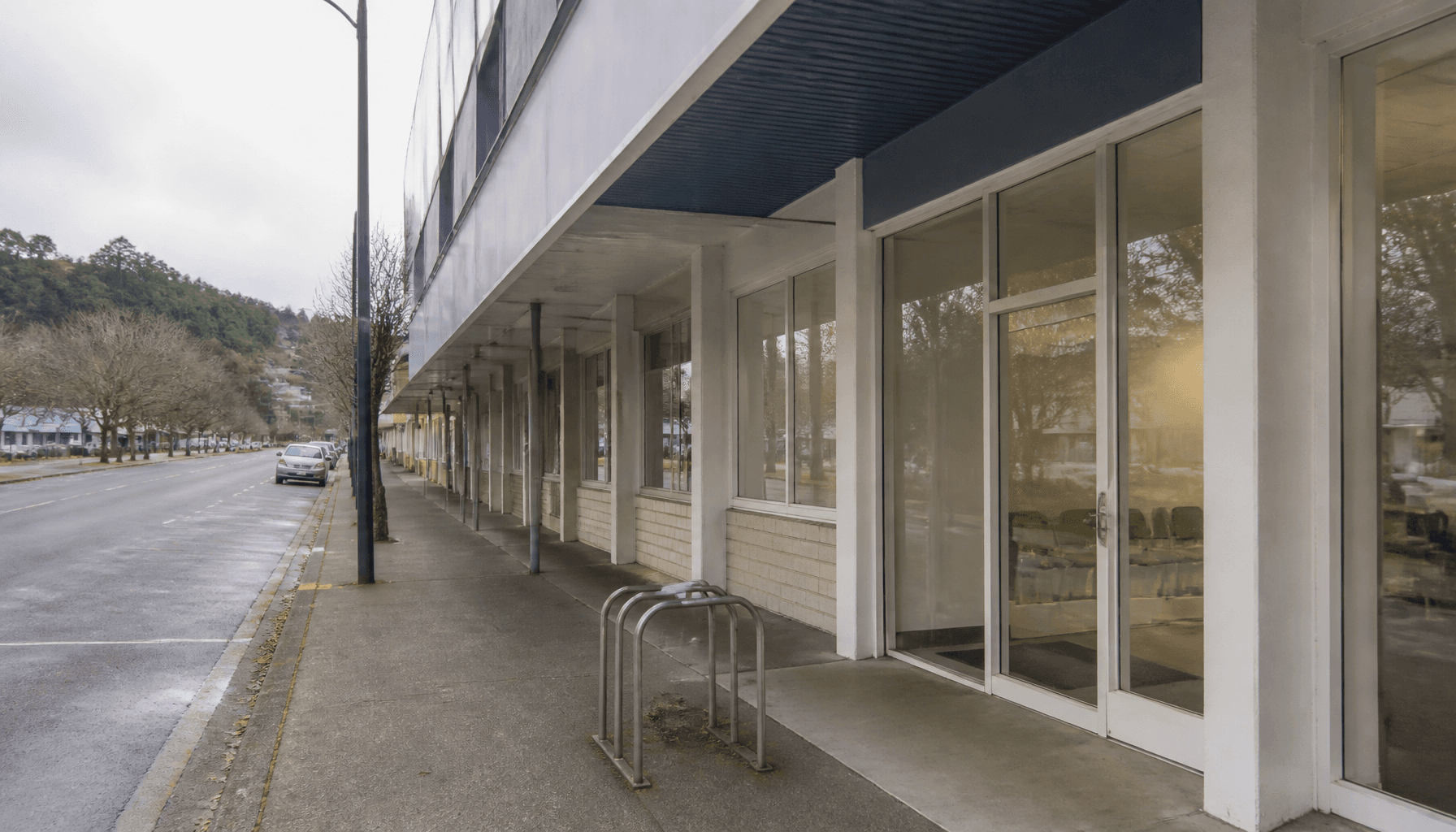 Exterior of a New Zealand social services office on a quiet street