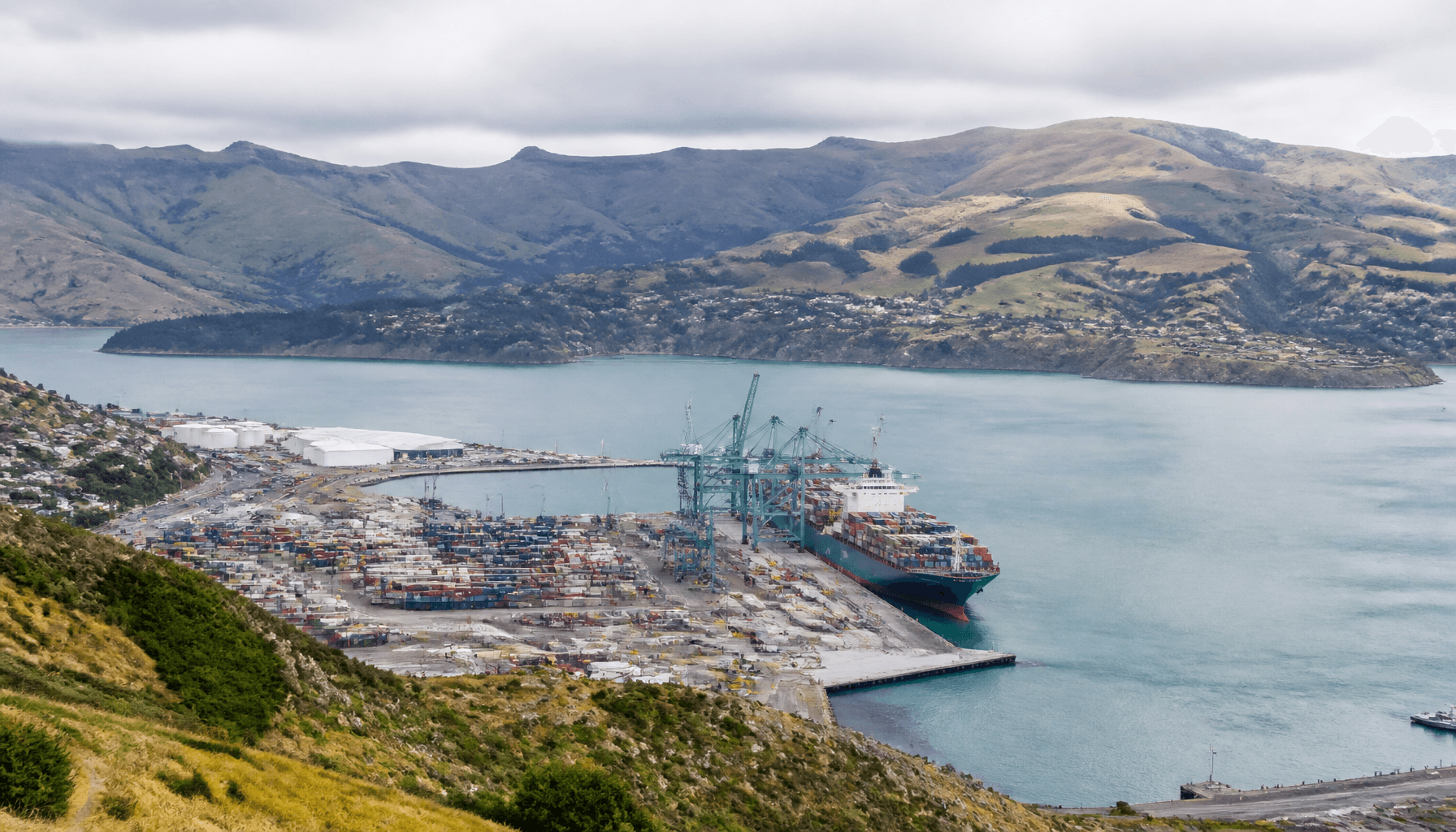 Lyttelton Harbour container terminal and cranes with ship at berth