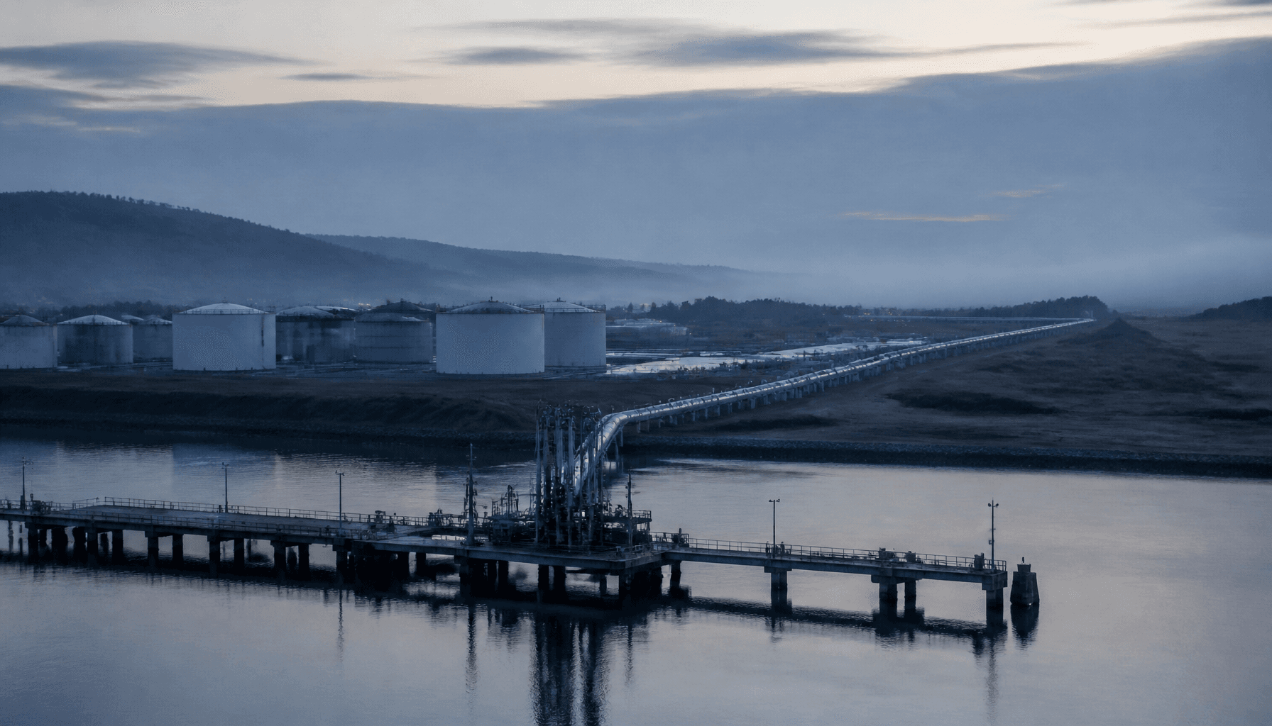 Dawn view of a Northland fuel terminal tank farm and empty import jetty